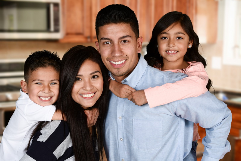 Happy young couple who are standing with their son