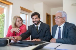 elderly couple sitting with an attorney during estate planning